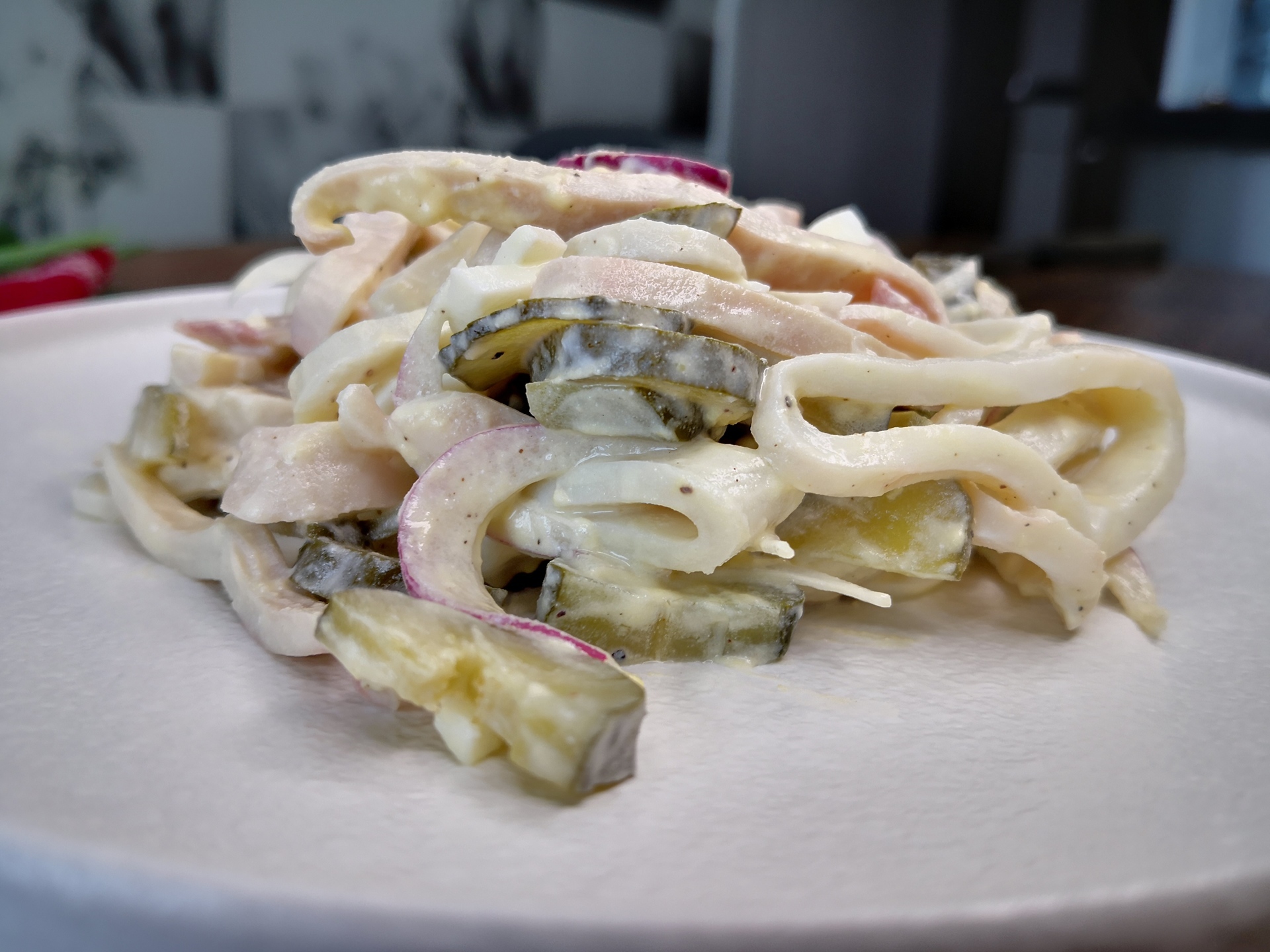 Фото к рецепту: Салат с кальмарами, яйцом, грибами и маринованными огурцами 